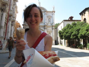 Student eating a pizza and gelato in Venice, Italy