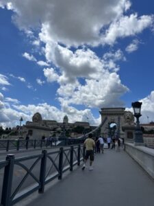 Széchenyi Chain Bridge spanning the Danube River in Budapest, with its iconic stone lions and suspension cables visible under a clear sky.
