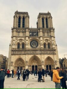Front view of the Notre-Dame Cathedral in Paris, showcasing its iconic gothic architecture and twin towers under.